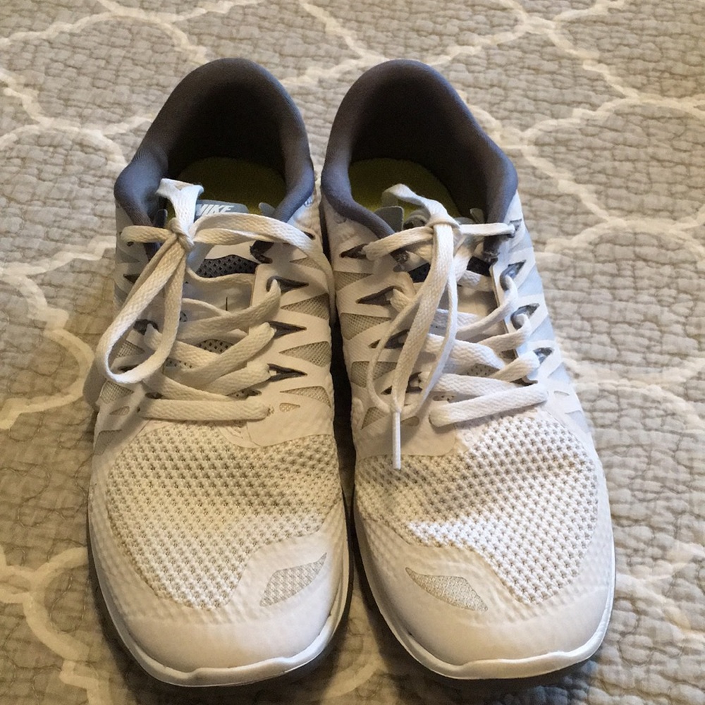 Gray and White Nike tennis shoes